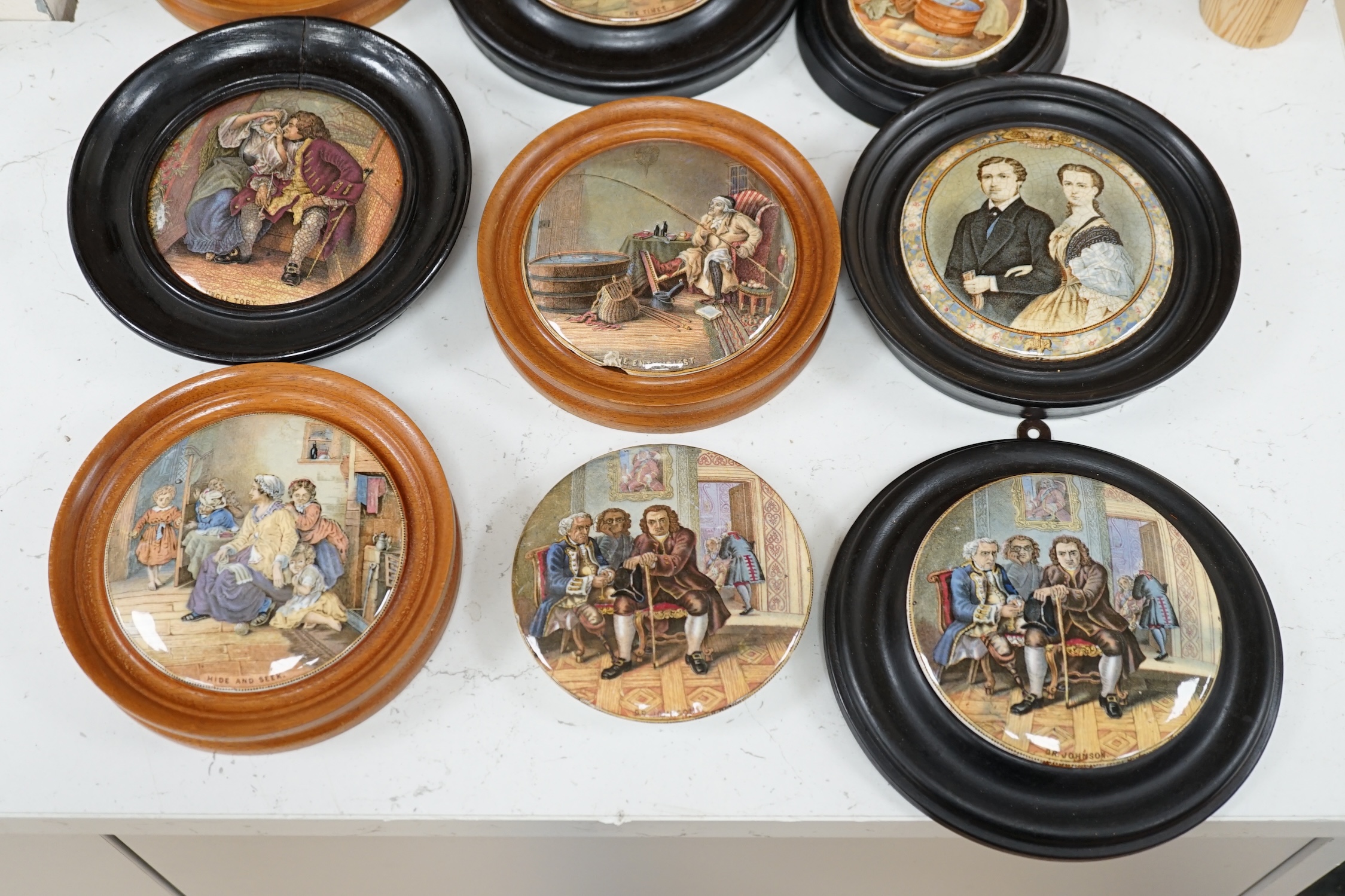 Nine 19th century framed pot lids including ‘Hide and Seek’ and ‘Uncle Toby’ and a jar and cover, largest overall 16cm diameter. Condition - fair to good